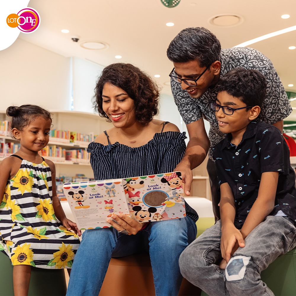 Children engrossed in books at a cozy library reading corner.