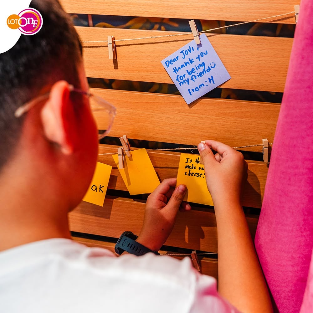 Memory wall with handwritten notes at Lot One