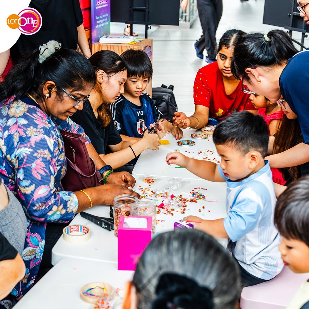 Children making bead friendship bracelets at Lot One