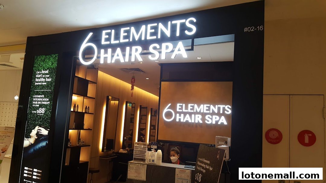 The entrance of '6 Elements Hair Spa' with illuminated signage and a promotional display.