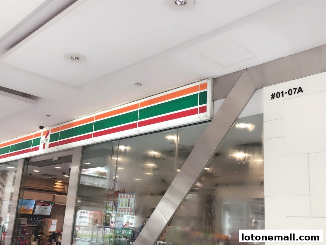 The exterior of a 7-Eleven convenience store with its iconic logo and colorful stripes.
