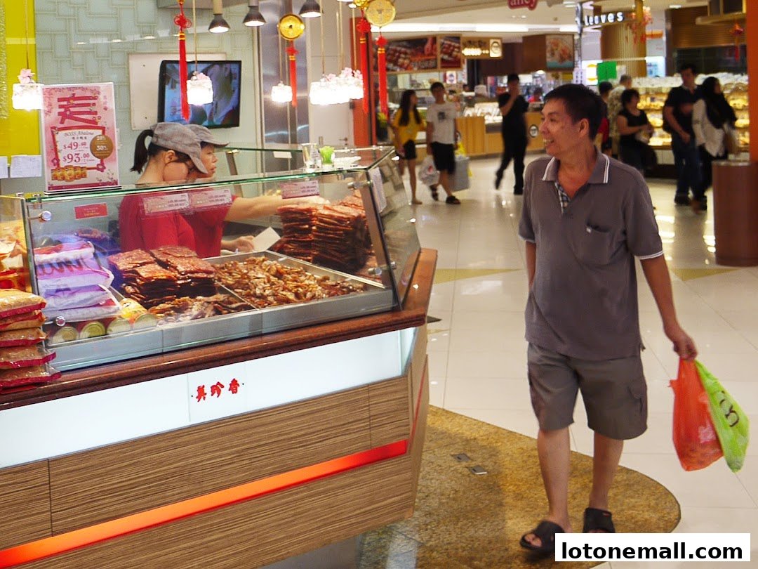 A man walks past a display of bak kwa at Bee Cheng Hiang.