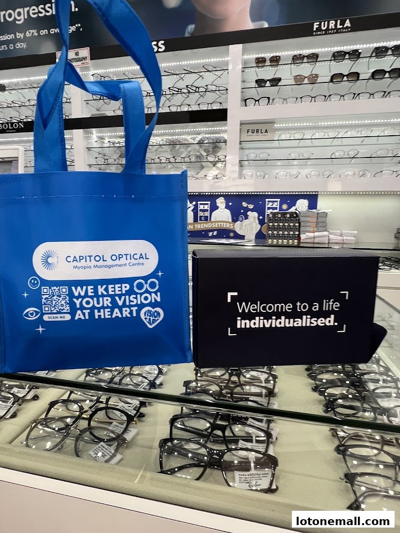 A display of eyeglasses and a branded tote bag at Capitol Optical.
