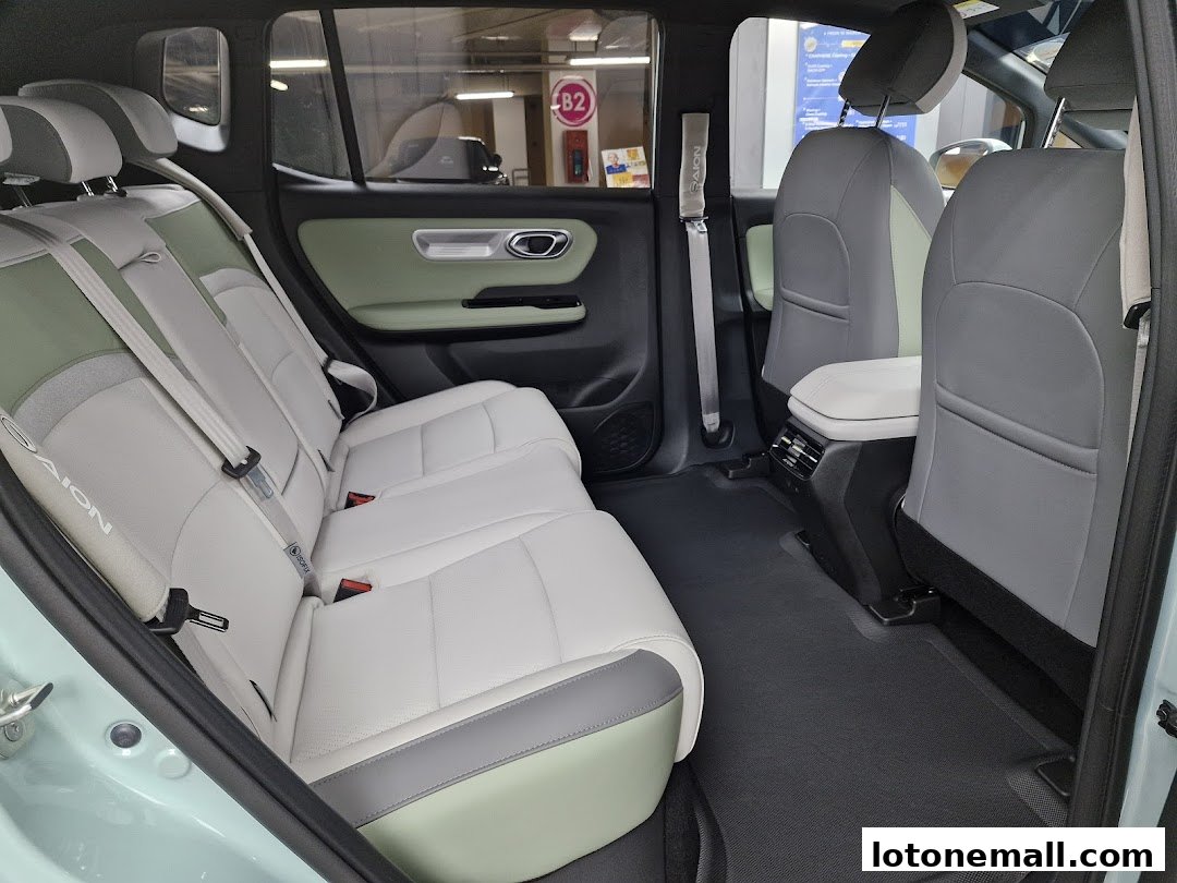 Interior view of a car's rear seats, featuring a two-tone design with light and dark grey upholstery.