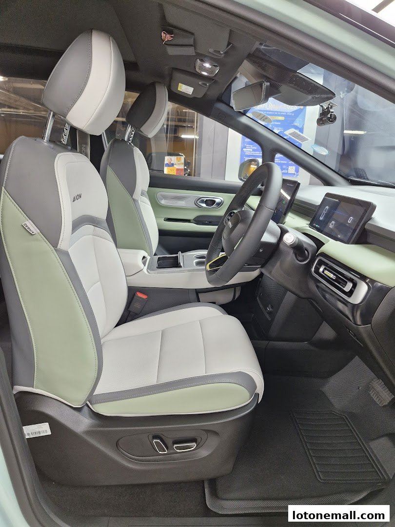 Interior view of a modern car with comfortable, two-tone seats and a digital dashboard.