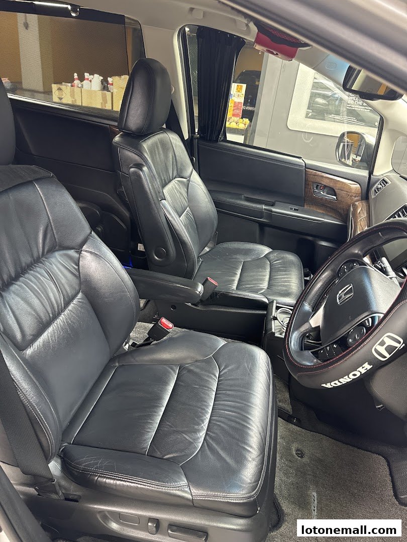 Interior view of a car's front passenger seats and dashboard, showcasing leather upholstery.