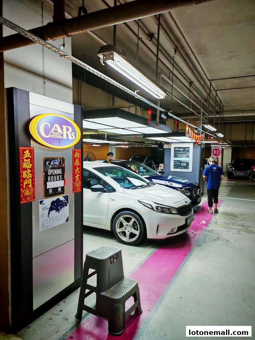 A car showroom with cars parked and a sign for CARs International.