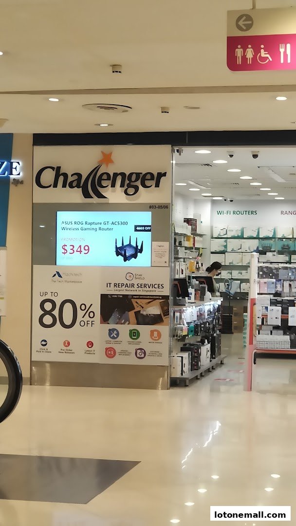 The Challenger electronics store front with a promotion for a wireless gaming router and IT repair services.