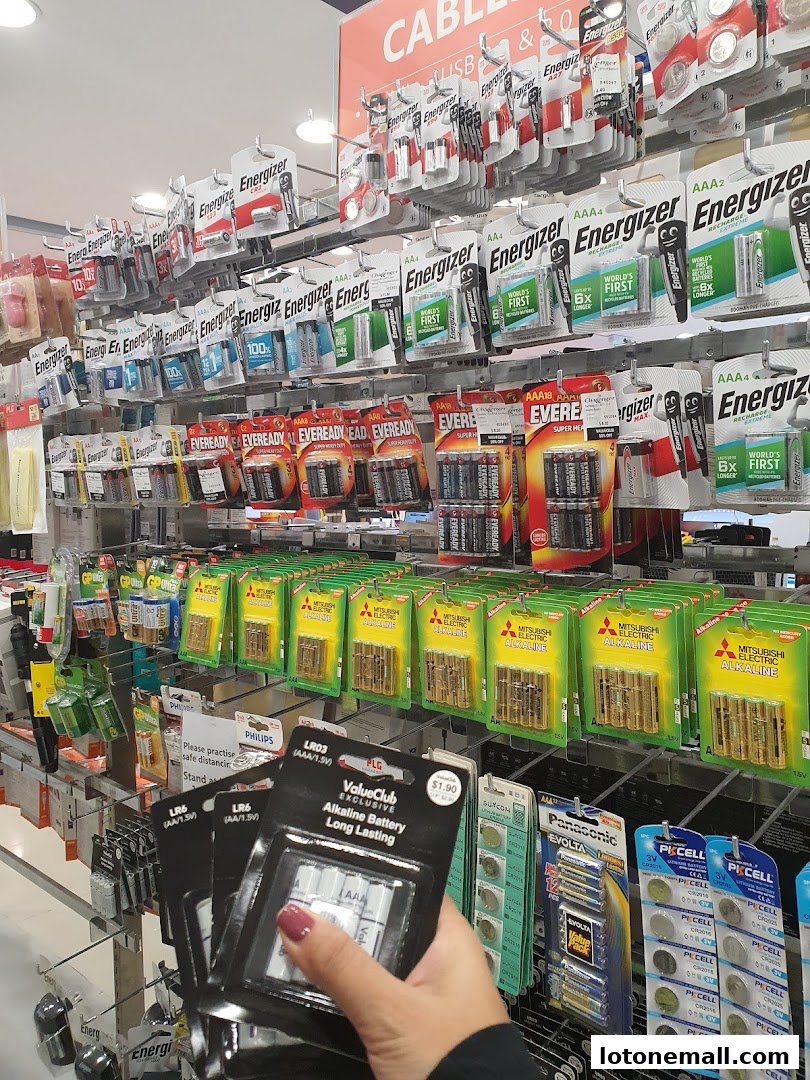 A wide selection of batteries, including Energizer, Eveready, and Mitsubishi Electric, neatly displayed on shelves.