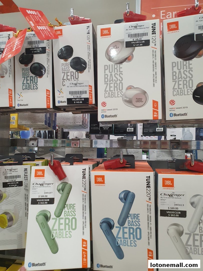A display of various JBL wireless earbuds in their packaging, showcasing different models and colors.
