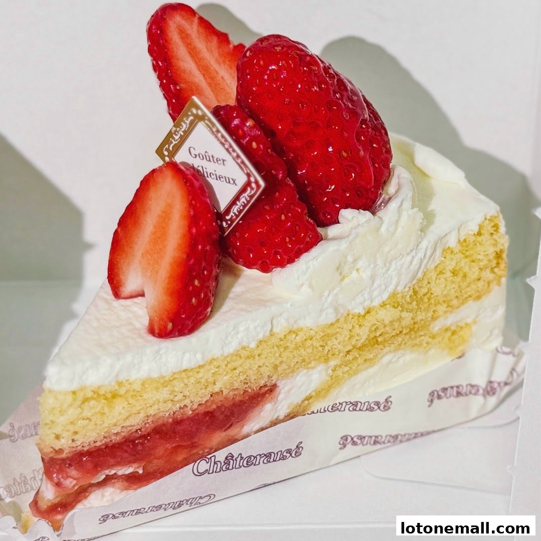 A slice of strawberry shortcake with fresh strawberries and whipped cream.