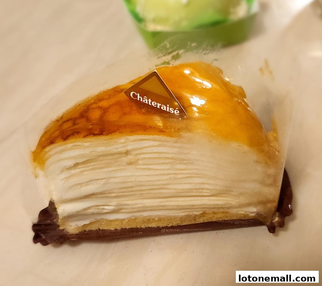 A slice of layered cake with cream and a glossy topping, branded Châteraisé.