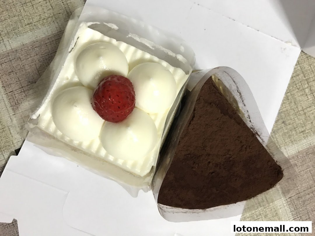 Two delicious cakes, one with cream and strawberry, the other chocolate, presented in packaging.