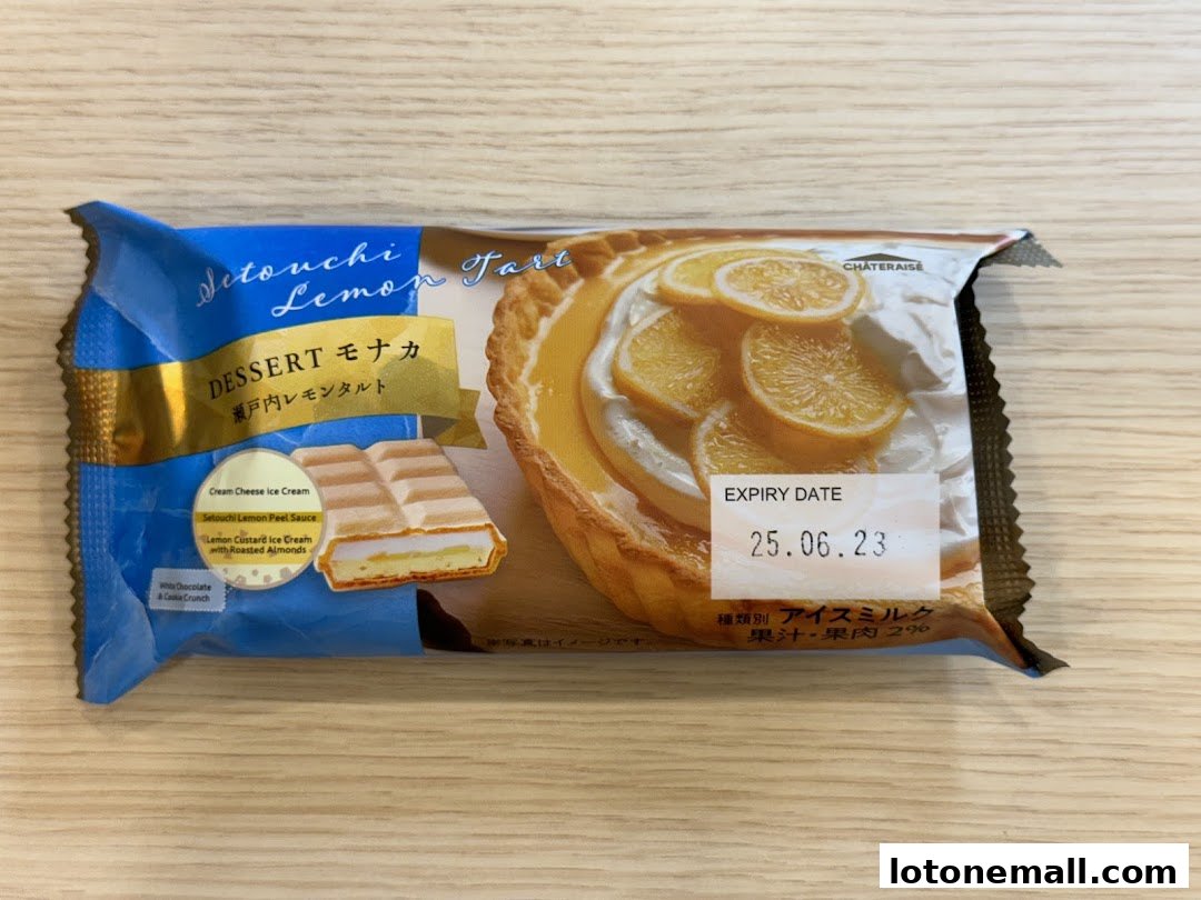 A packaged Setouchi Lemon Tart dessert with lemon slices and cream.