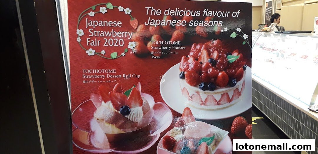 A promotional poster for a Japanese Strawberry Fair featuring strawberry desserts and cakes.