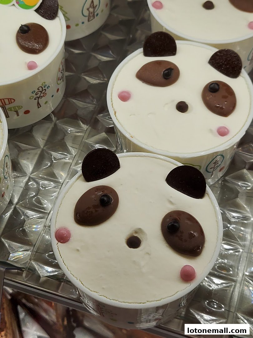 Close-up of adorable panda-themed desserts in individual cups.