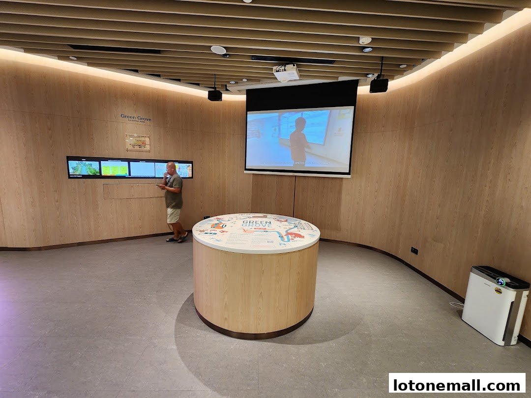 A man interacts with digital displays in a modern library exhibition space.