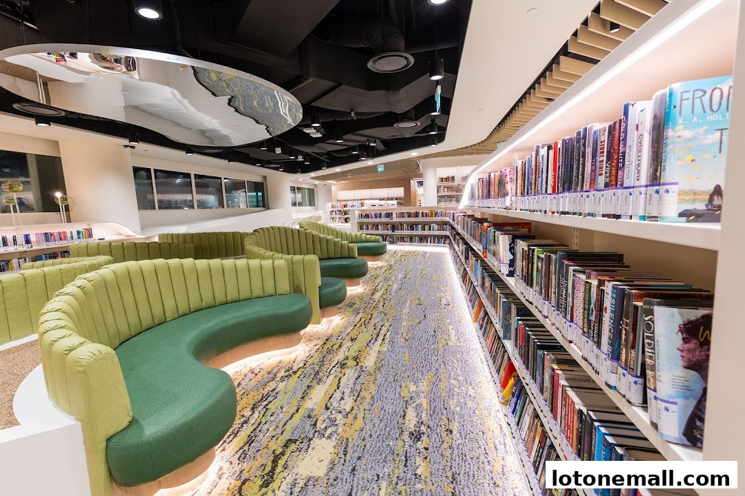 Interior view of a modern library with comfortable seating and bookshelves.