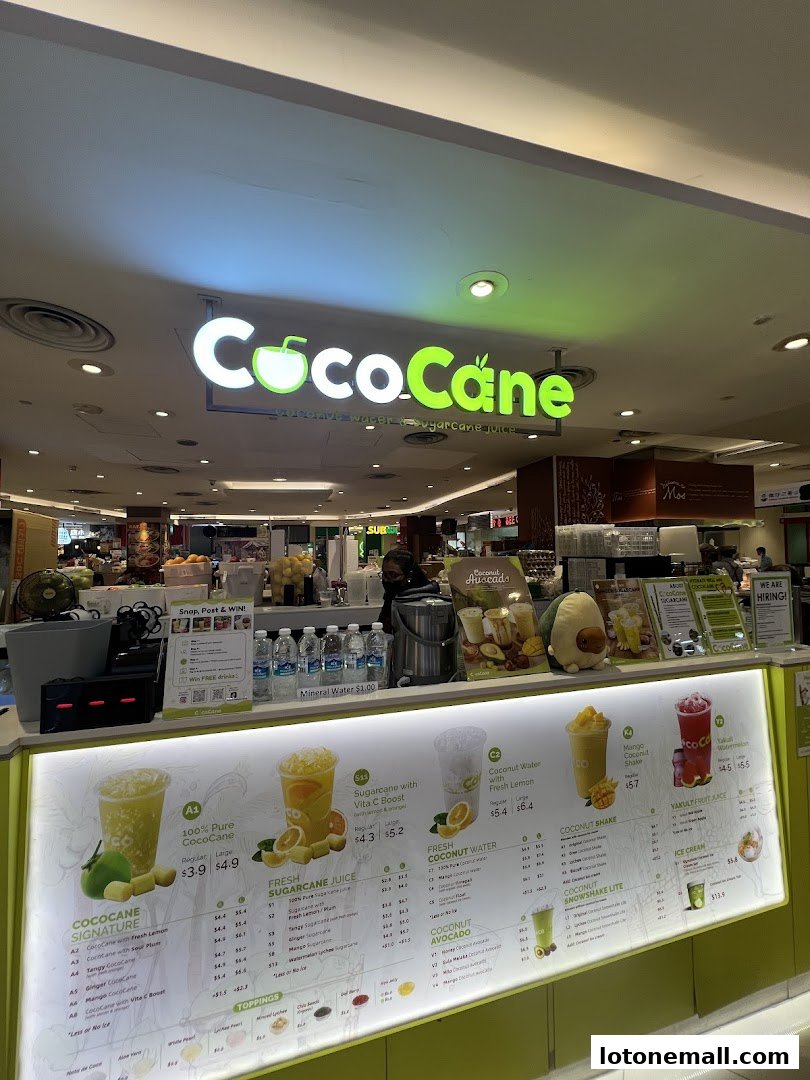 A brightly lit menu board for CocoCane, showcasing various sugarcane juices and coconut drinks.
