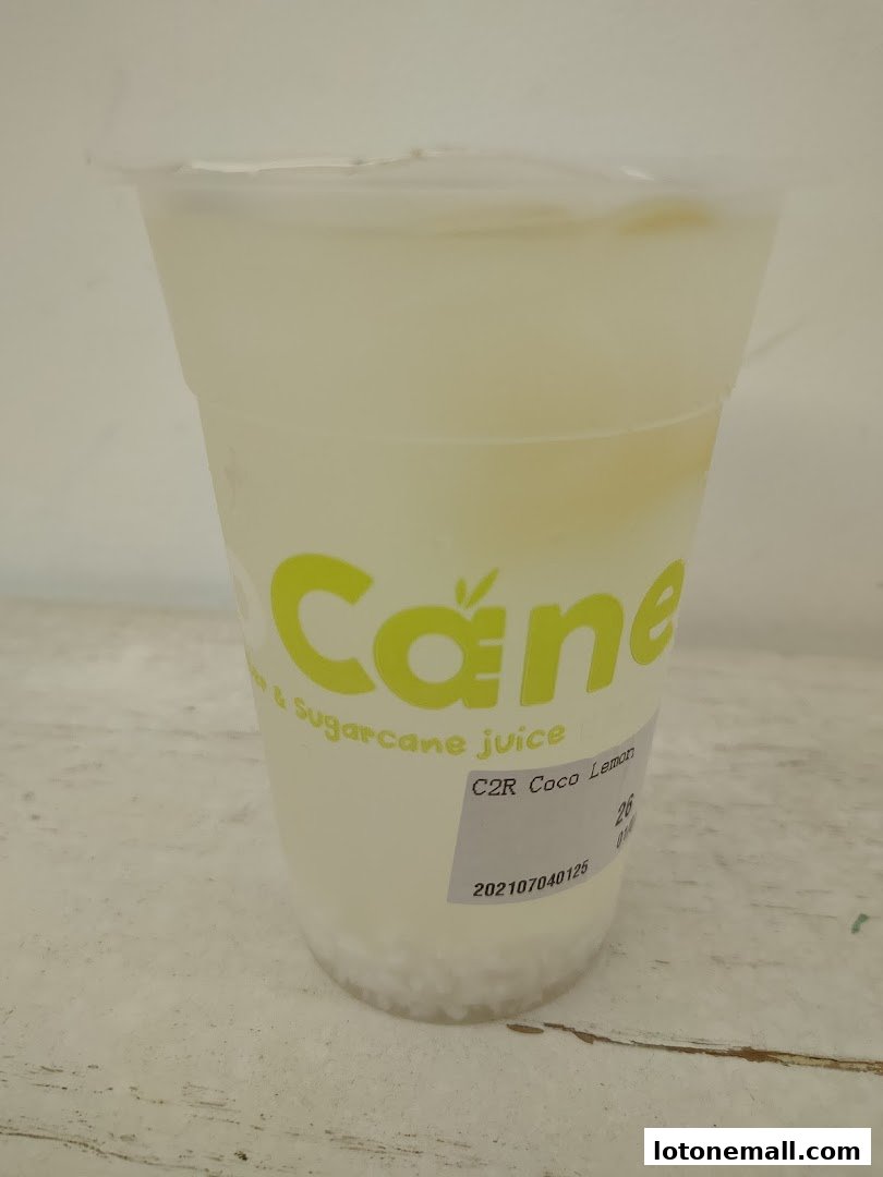 A close-up of a CocoCane drink with the logo and product name visible.