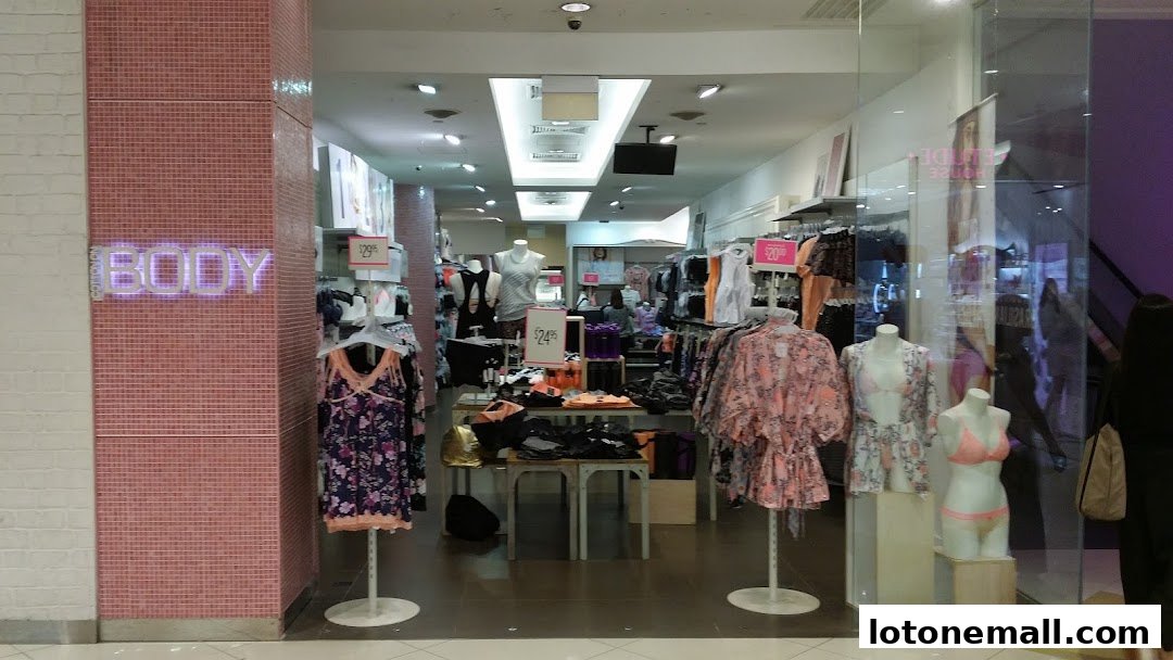 The entrance of Cotton On Body shop displaying clothing on mannequins and racks.