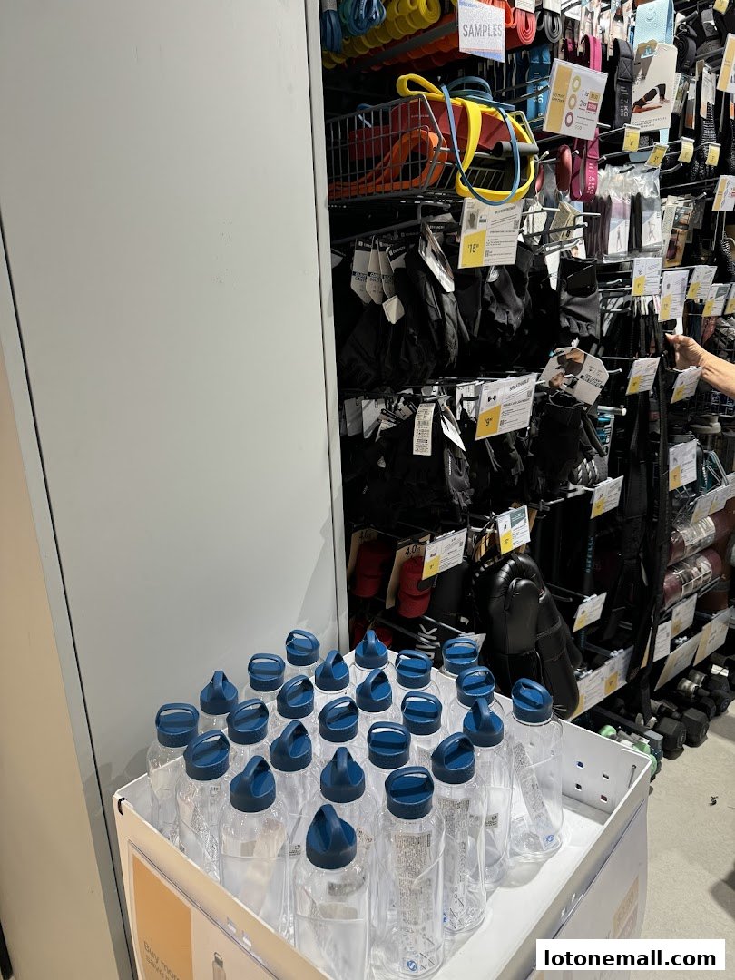 Display of fitness accessories and water bottles at Decathlon.