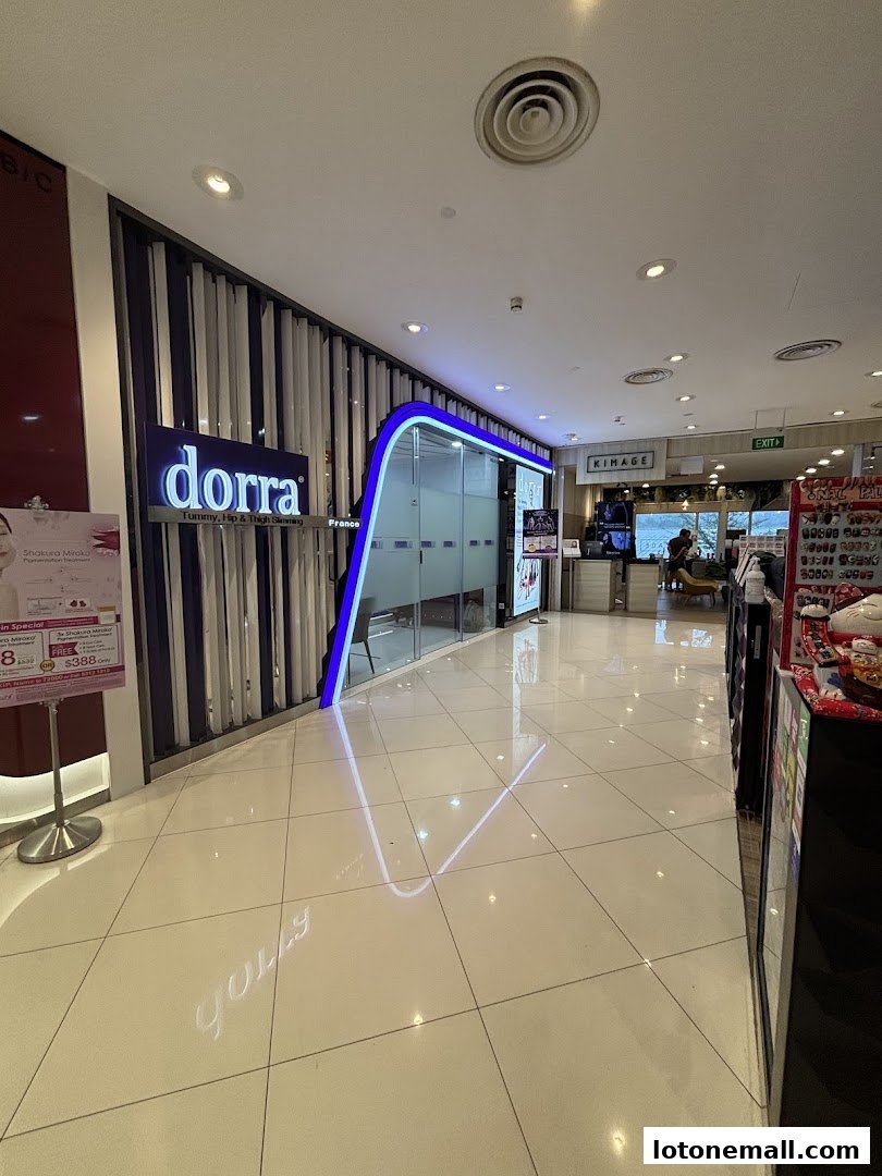 The entrance to Dorra Slimming, a beauty treatment center, with its illuminated sign and modern interior.