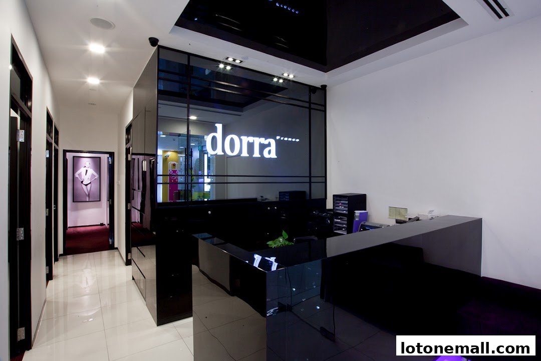 Interior view of a modern slimming salon with a reception desk and the shop's logo.