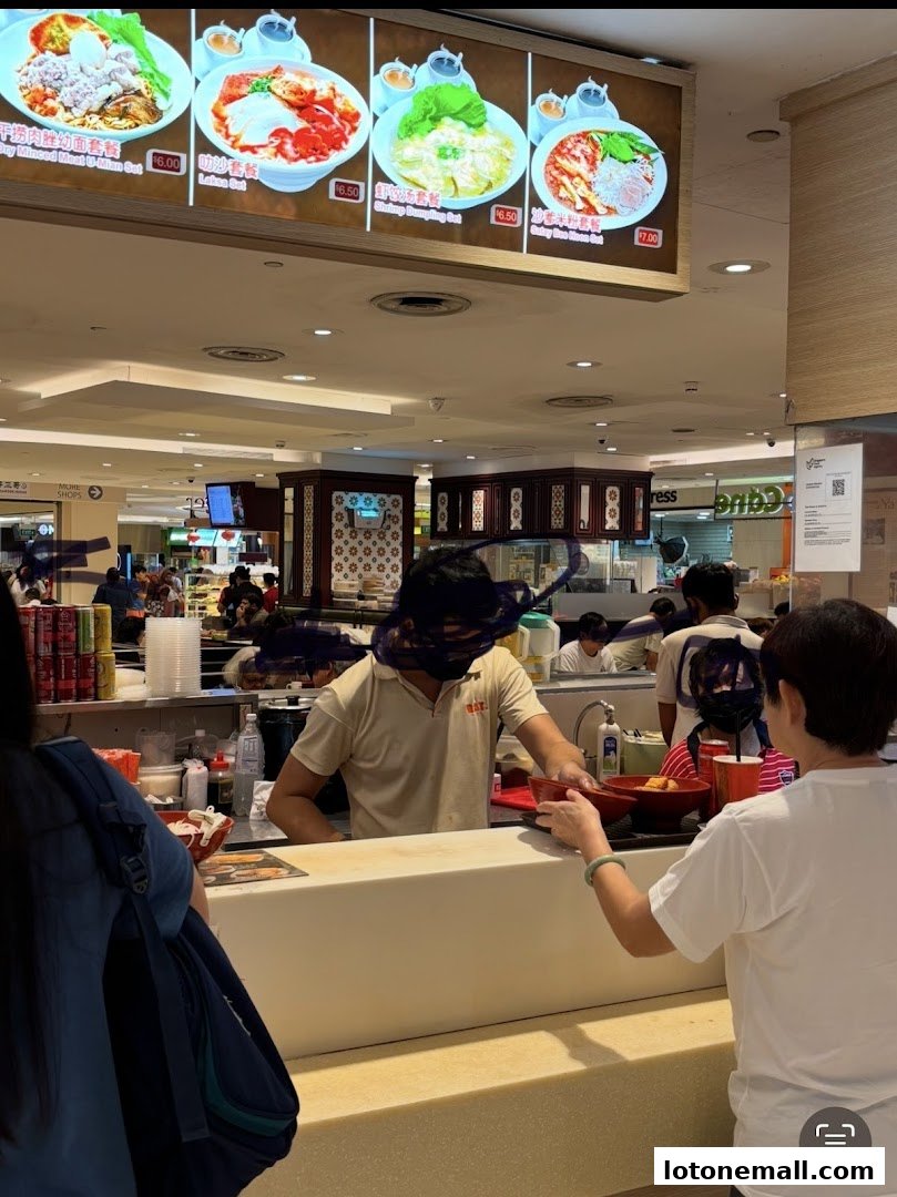 A food stall counter with a menu board displaying various meal sets and prices.