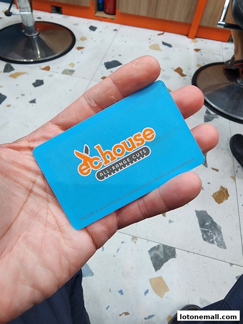 A hand holds a blue ticket with the EC House logo and text.
