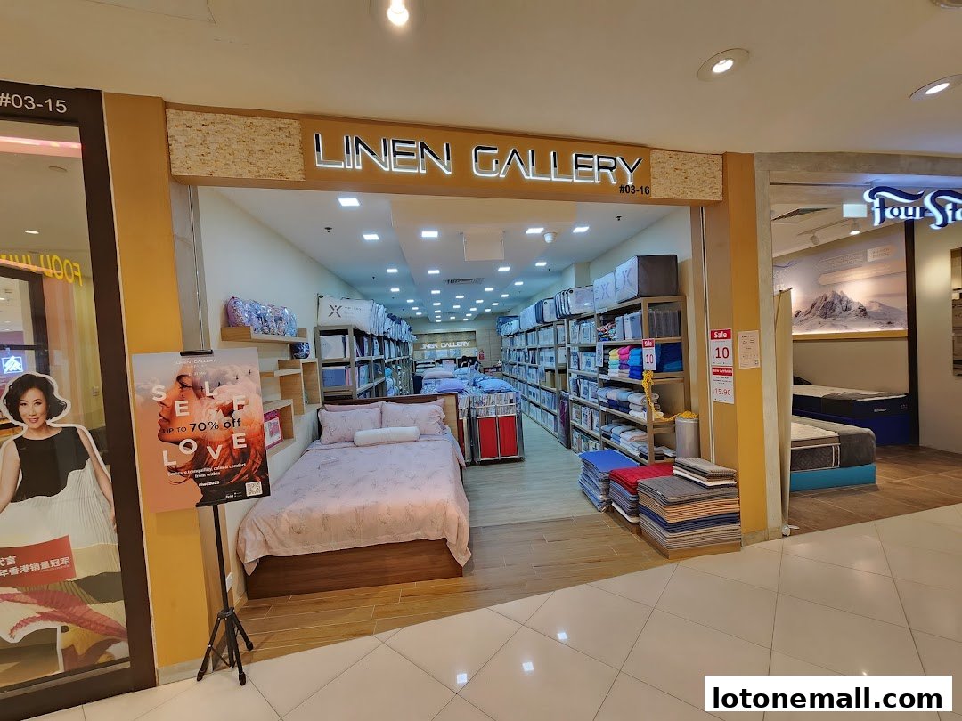 The entrance of Linen Gallery, a shop selling bedding and linens, with a sale poster.