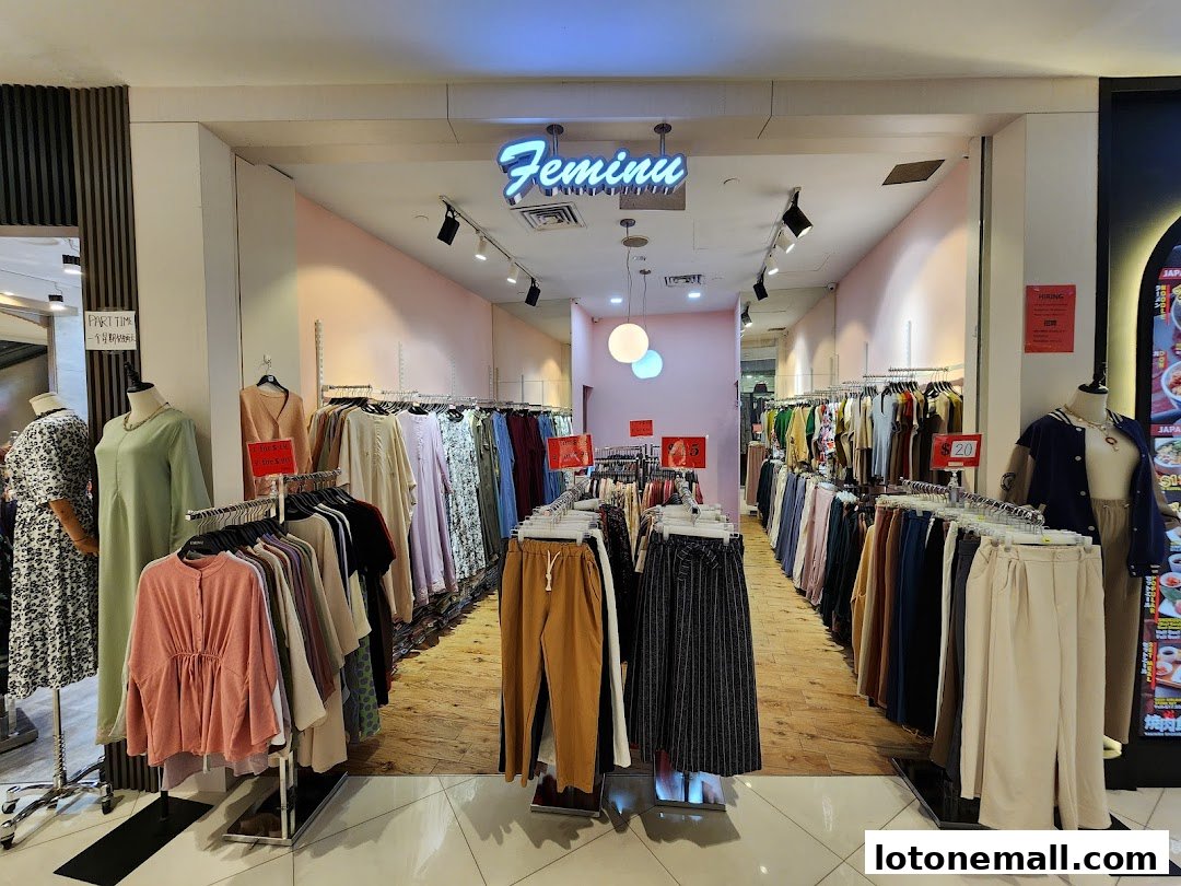 Interior view of a clothing store with racks of women's apparel and mannequins.