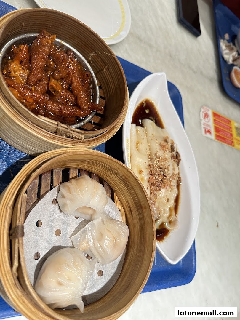 A close-up of delicious dim sum dishes, including steamed dumplings and braised chicken feet.