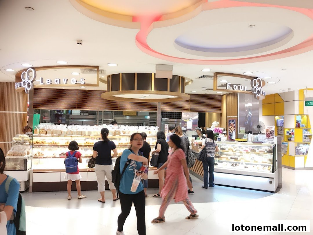 Customers browse a bakery with a wide selection of bread and pastries on display.