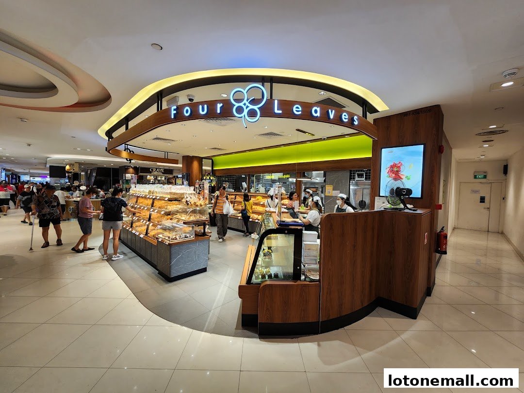 A busy bakery shop with a wide selection of pastries and breads on display.