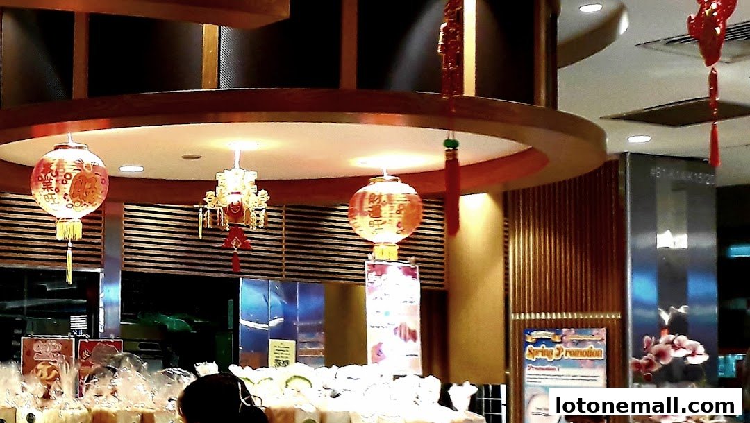 Interior of a shop with decorative lanterns and promotional posters.