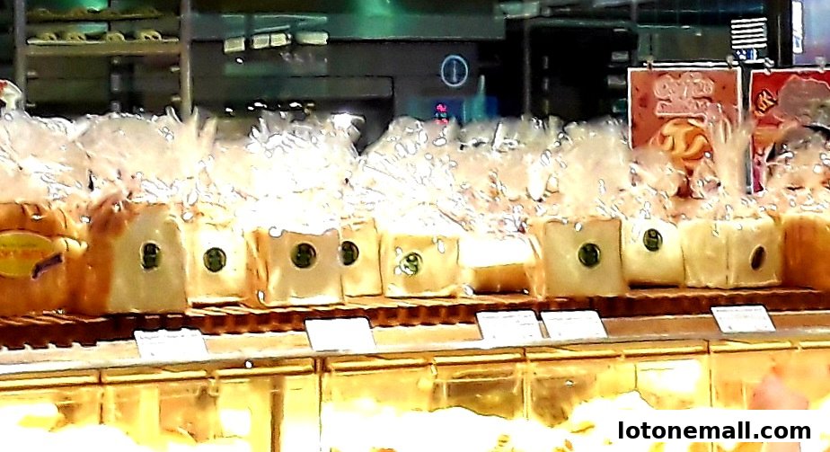 A display of freshly baked loaves of bread, individually wrapped and presented.