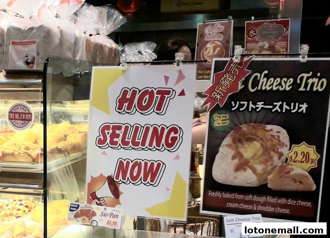 A bakery display featuring hot selling items like Sio Pan and Cheese Trio.