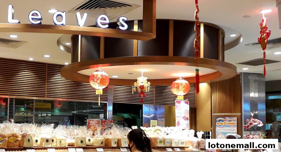 A bakery shop interior with loaves of bread on display and festive lanterns.