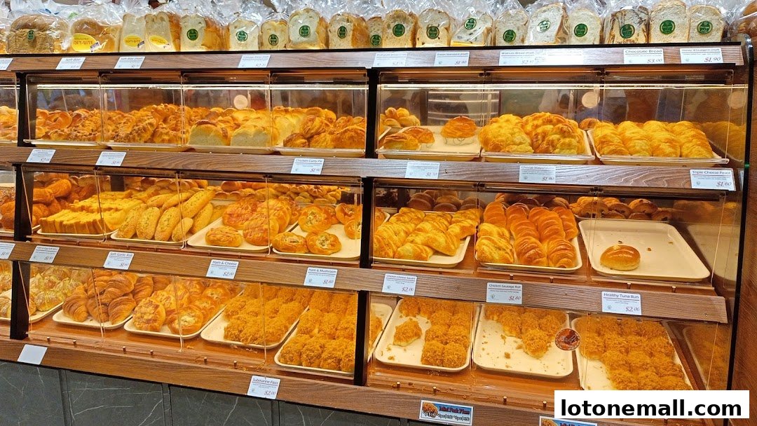 A display of freshly baked breads and pastries in a bakery shop.