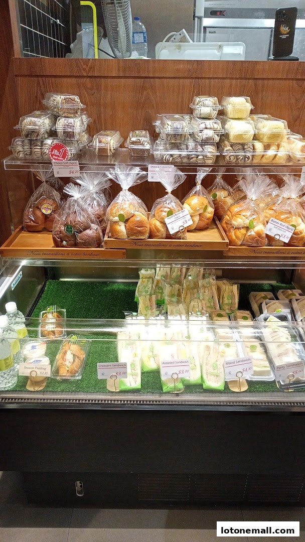 A display case filled with various baked goods and sandwiches from Four Leaves bakery.