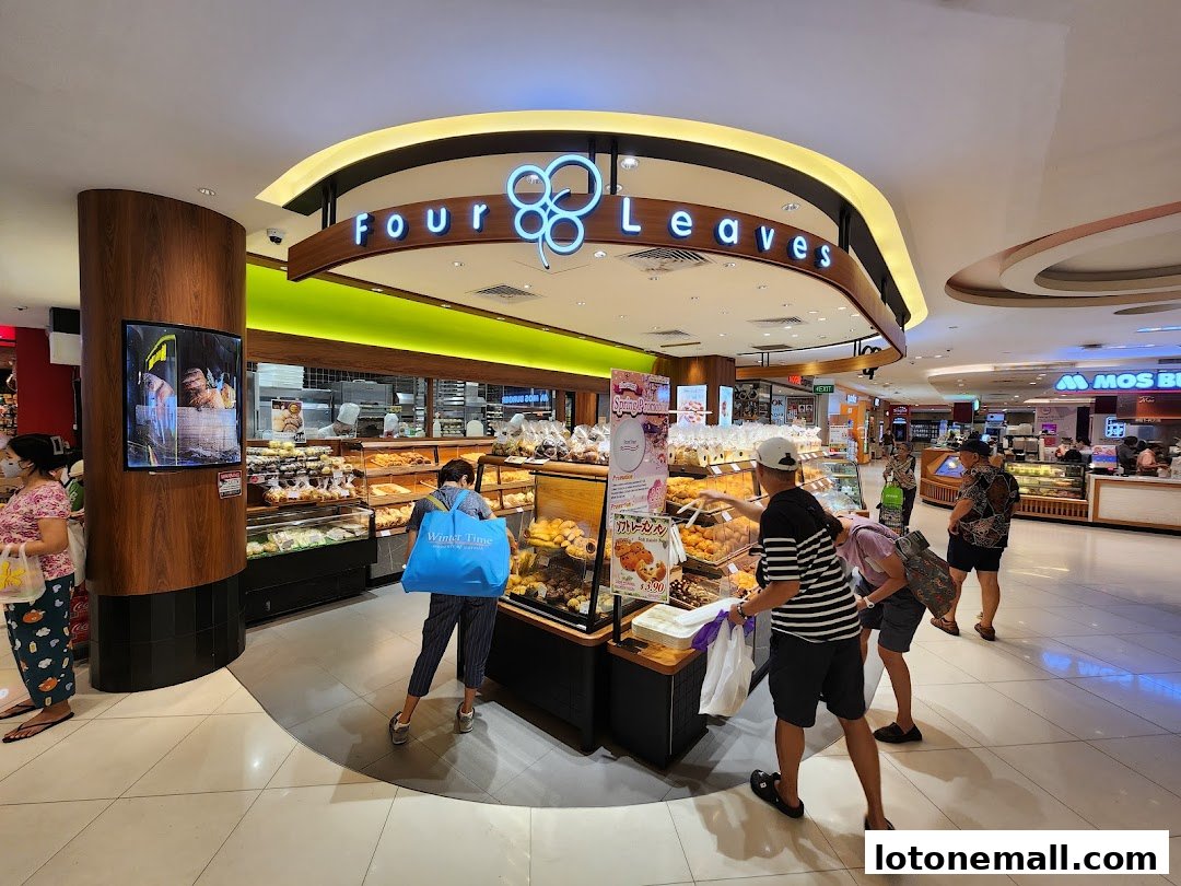 Customers browse baked goods at the Four Leaves bakery in a shopping mall.