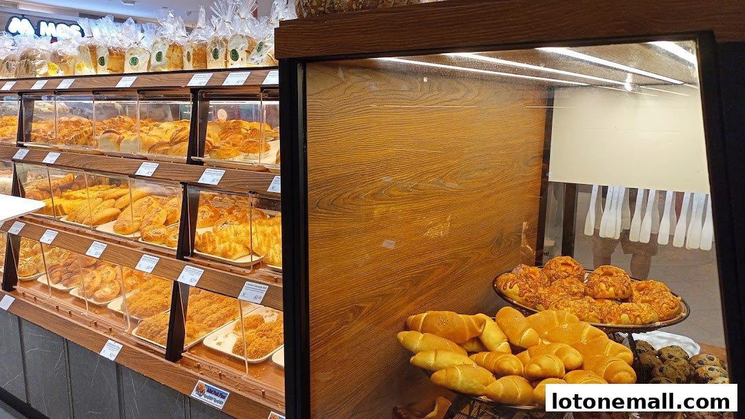 A display of freshly baked bread and pastries in a bakery.