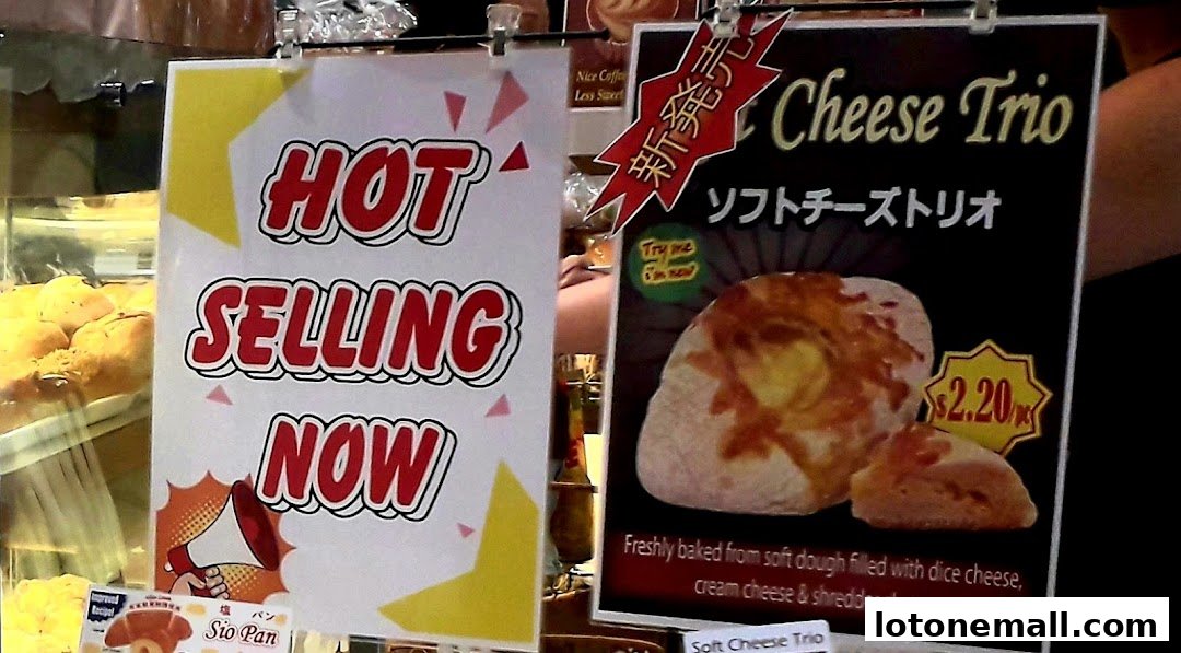 Signs advertising hot selling items and a 'Cheese Trio' pastry at a bakery.