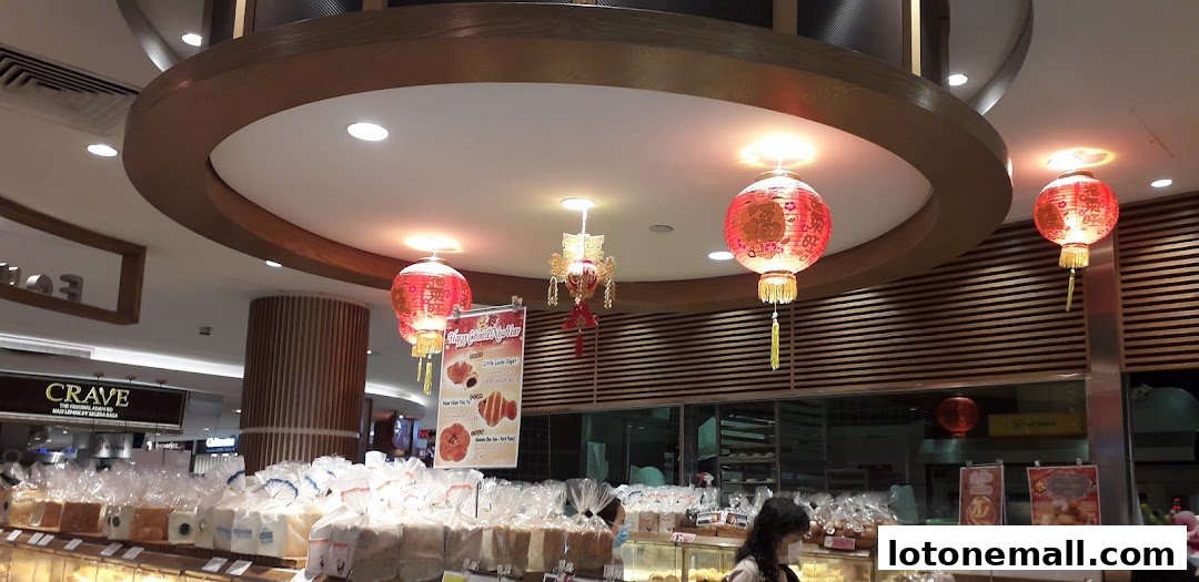 A bakery display with bread, pastries, and festive Chinese New Year decorations.