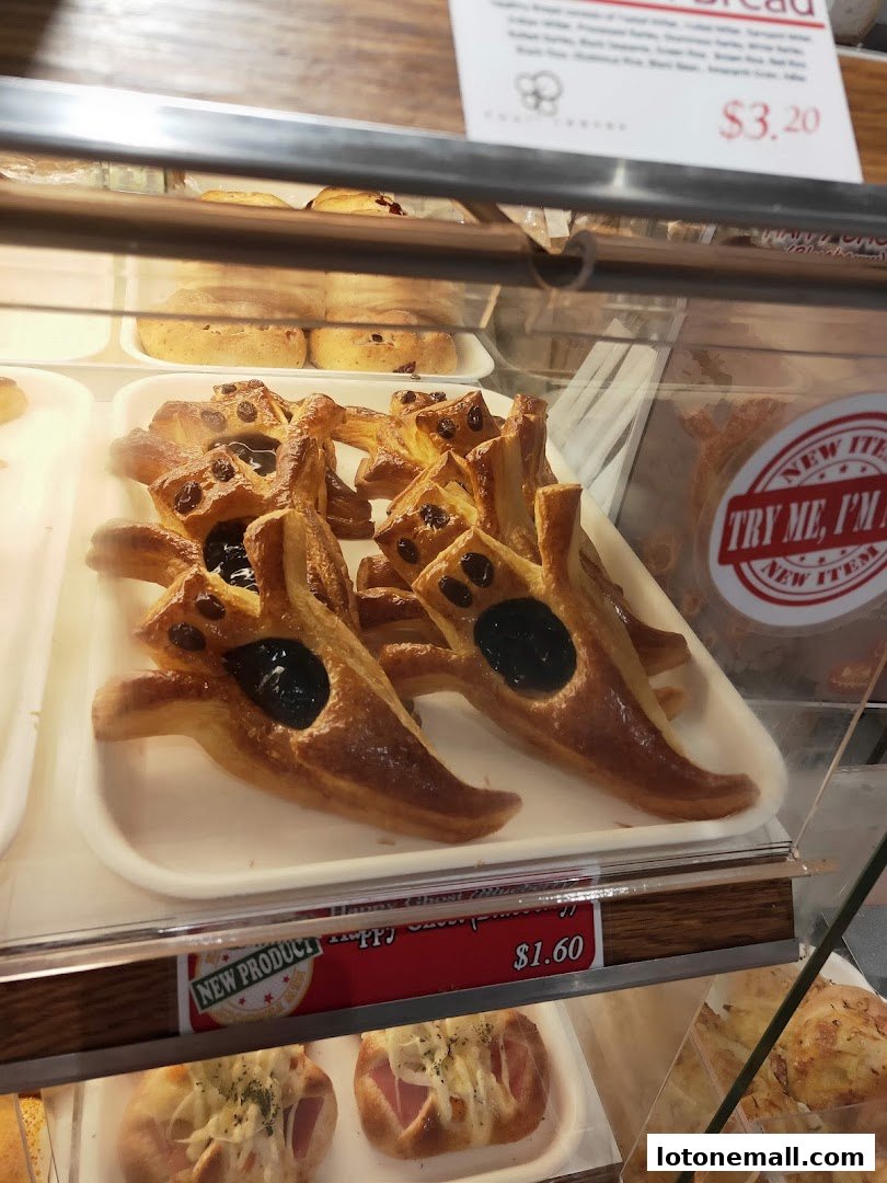 A display case filled with freshly baked pastries, including star-shaped ones with jam.