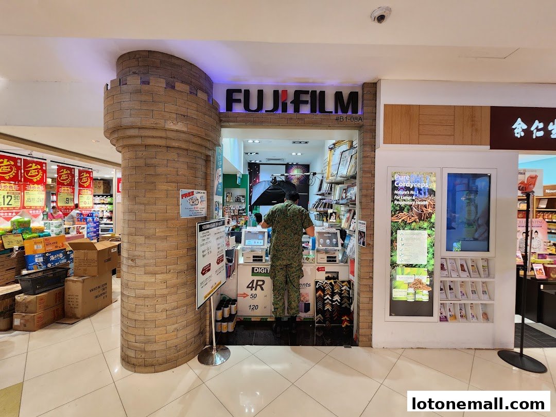 Fujifilm Mach Photo shop entrance with a staff member serving a customer.