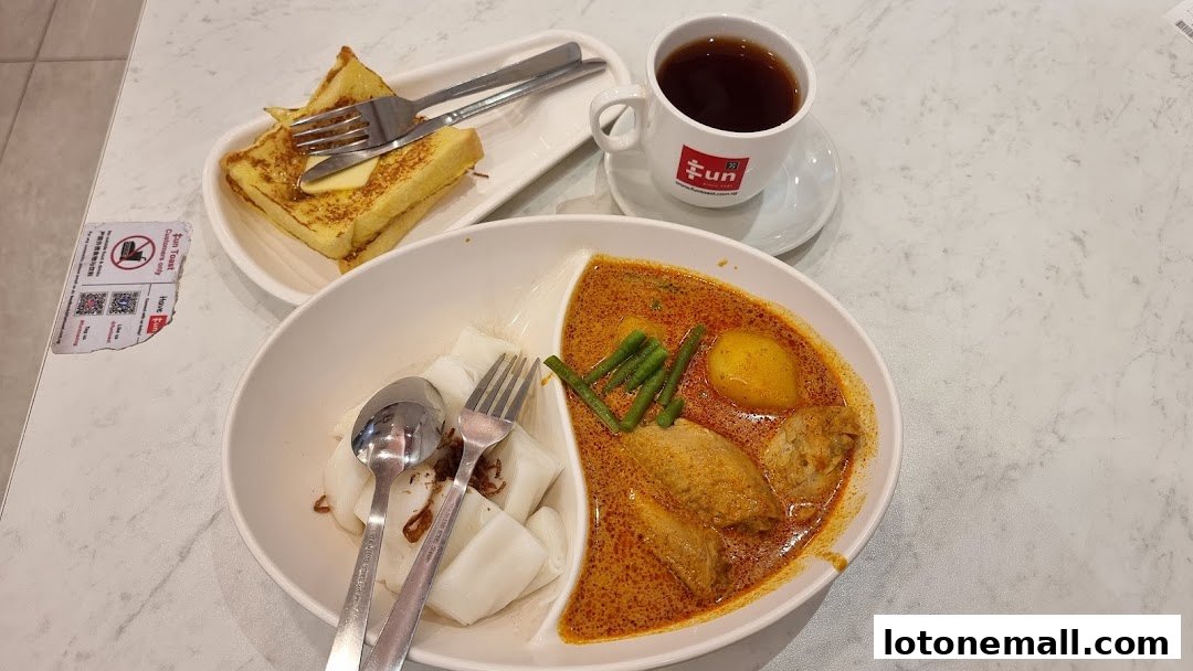 A meal at Fun Toast featuring curry noodles, chee cheong fun, butter toast, and coffee.