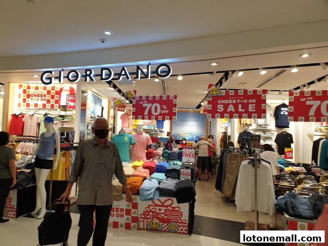 Giordano store interior with colorful apparel and sale signs up to 70% off.