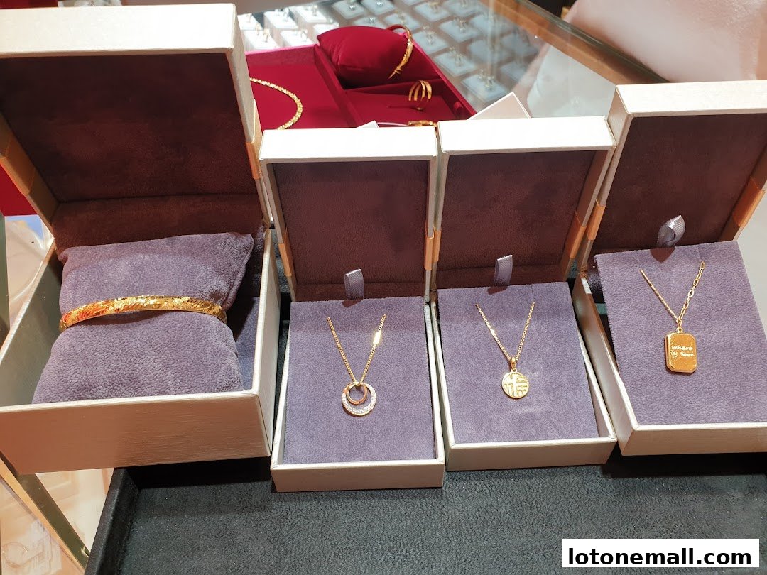 Beautiful gold jewelry, including a bracelet and necklaces, displayed in open boxes.